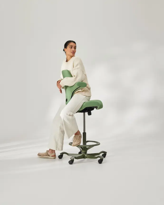 Fauteuil de bureau ergonomique HÅG Capisco en position assise active, dos à la table Chaise de bureau ergonomique HÅG Capisco correctement réglée